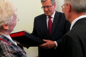 Prezydent Bronisław Komorowski odbiera z rąk Teresy Karol pamiątkowy prezent